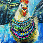 A painted white chicken with a red comb wearing colorful Mardi Gras beads on Bourbon Street in New Orleans