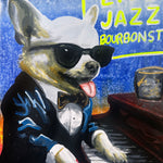 A colorful painted illustration of a white dog dressed in a black tuxedo with sunglasses, sitting at a piano and playing jazz music, with the text 'LIVE JAZZ BOURBONST' in yellow on a blue background.